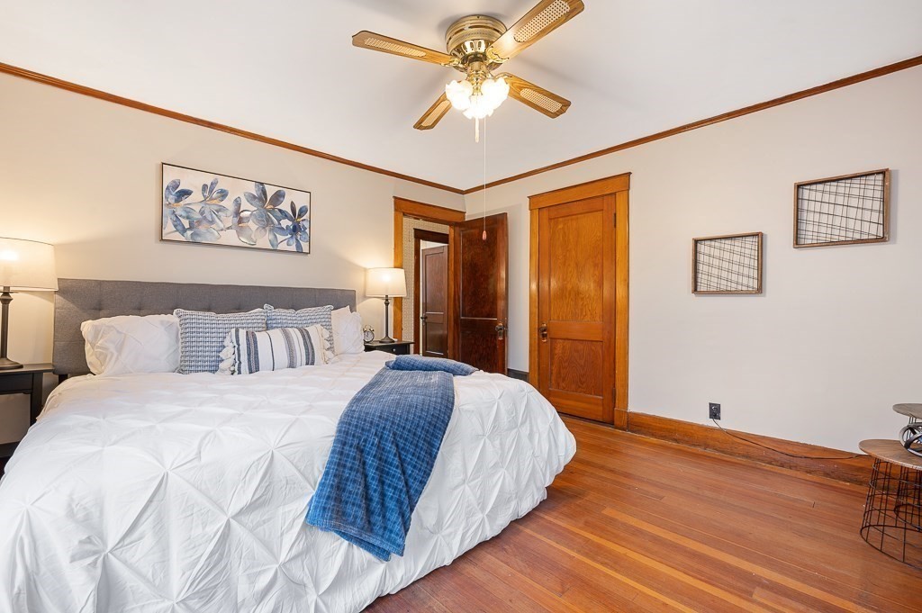 17 George Street Framingham, MA 01702 - Photo 18 of 38 a bedroom with a large bed and a chandelier