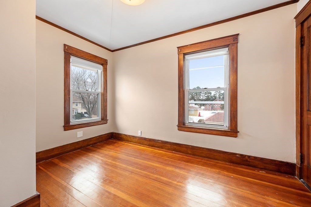 17 George Street Framingham, MA 01702 - Photo 24 of 38 a view of an empty room with window and wooden floor
