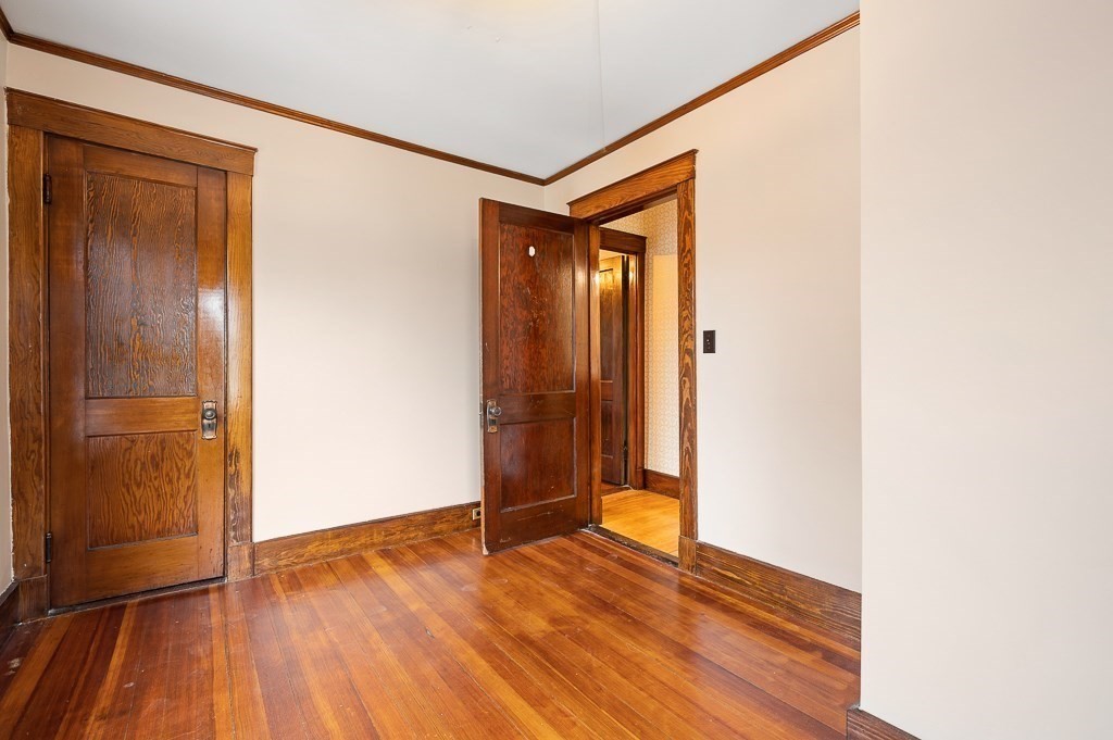17 George Street Framingham, MA 01702 - Photo 25 of 38 a view of an empty room with wooden floor and a bathroom