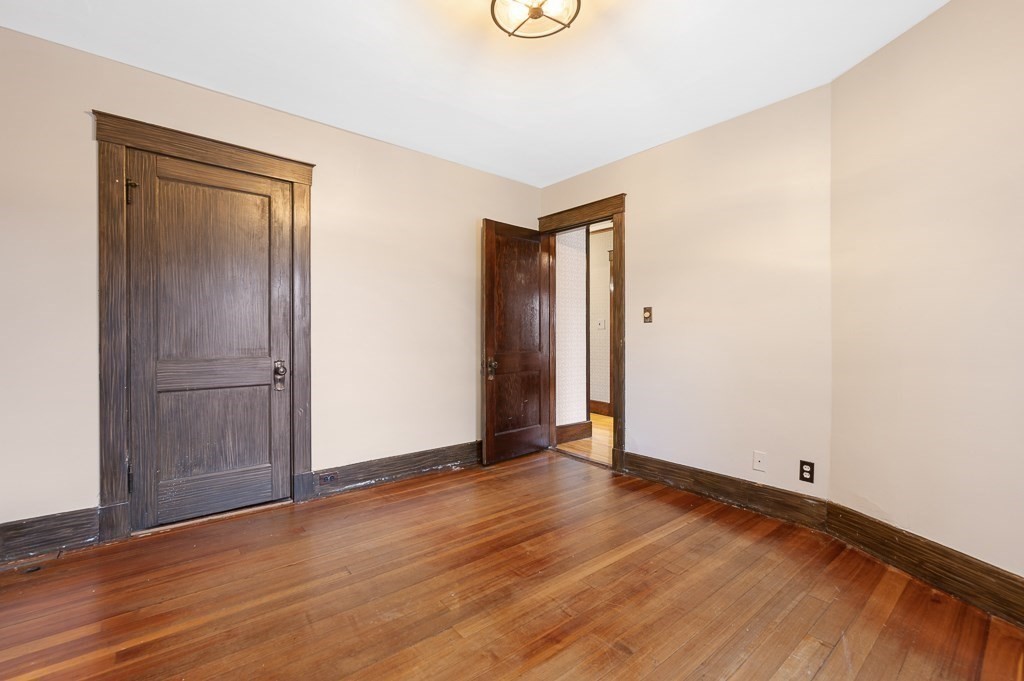 17 George Street Framingham, MA 01702 - Photo 26 of 38 an empty room with wooden floor and windows