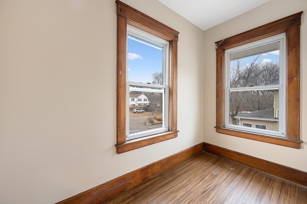 17 George Street Framingham, MA 01702 - Photo 27 of 38 a view of an empty room with wooden floor and a window