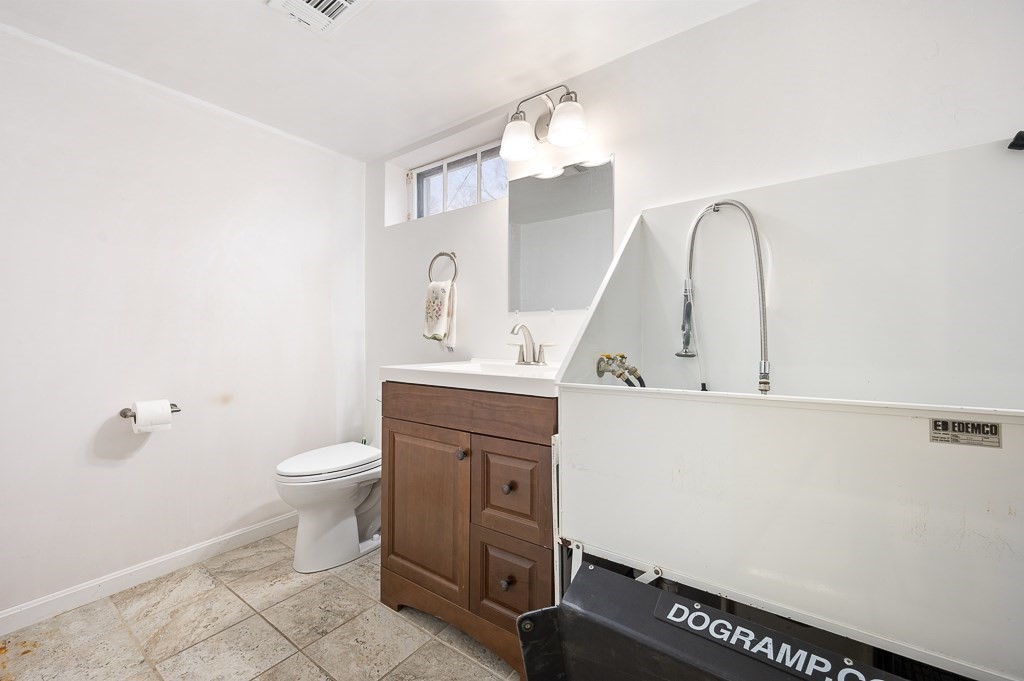 17 George Street Framingham, MA 01702 - Photo 28 of 38 a bathroom with a sink a toilet and a mirror