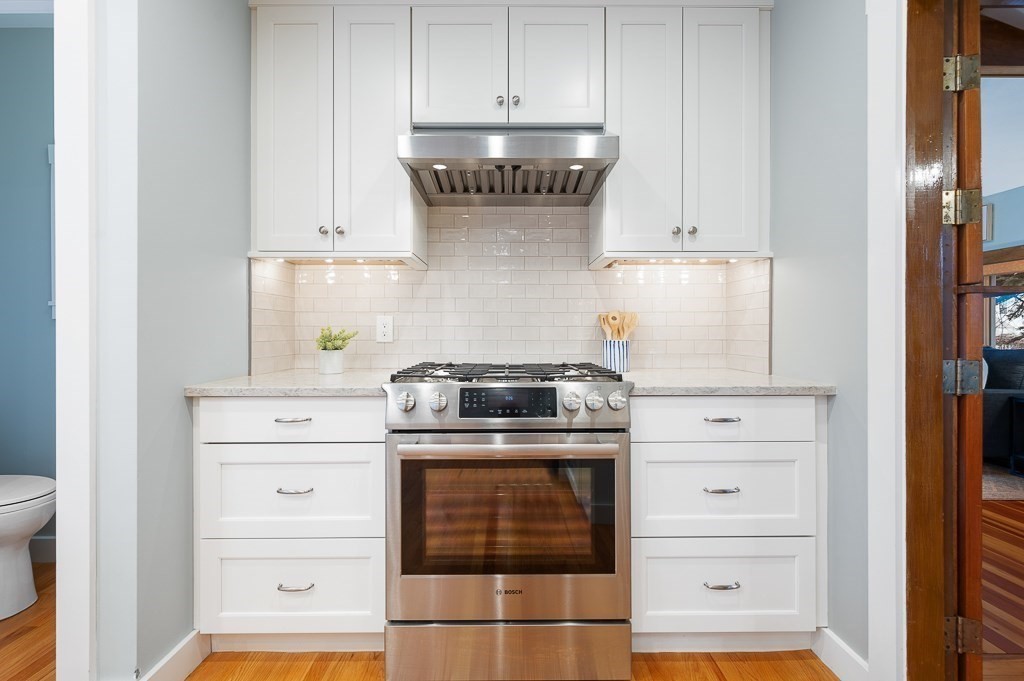 17 George Street Framingham, MA 01702 - Photo 10 of 38 a kitchen with granite countertop white cabinets and white appliances