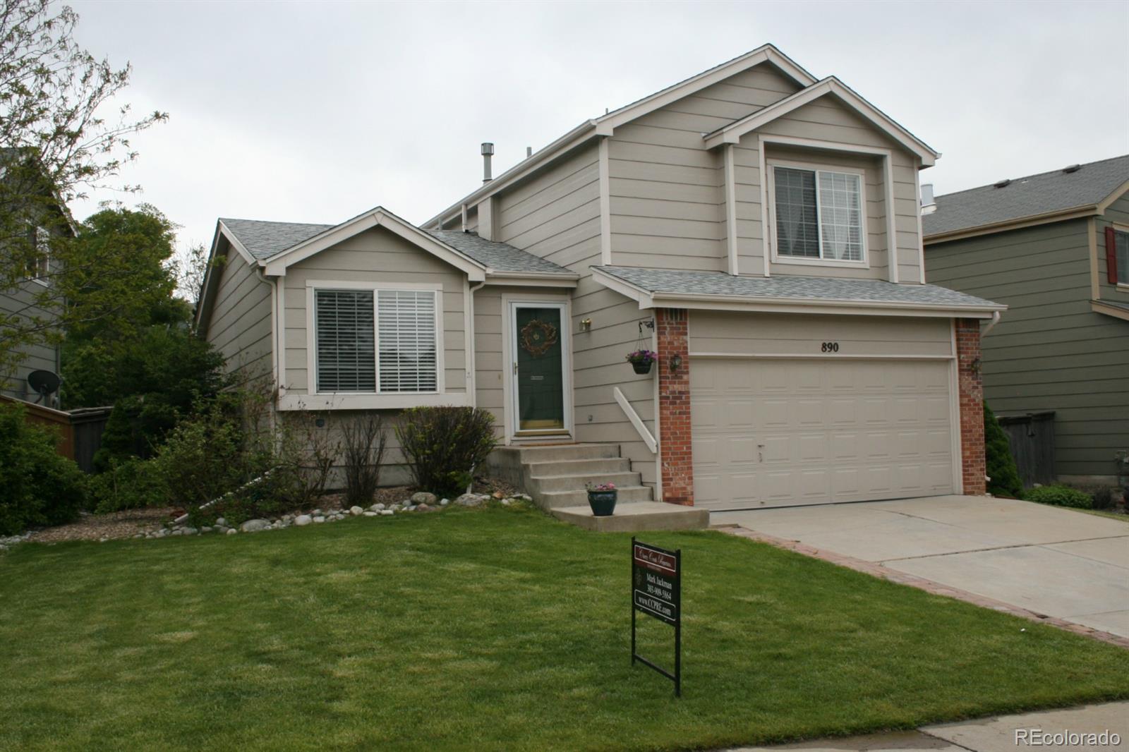 890 Timbervale Trail Highlands Ranch, CO 80129 - Photo 1 of 1 a front view of a house with a yard