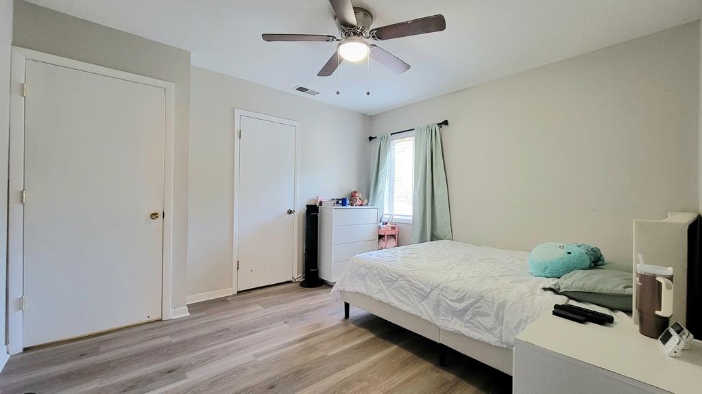 4804 Bruning Street Columbus, GA 31907 - Photo 12 of 14 a bedroom with a bed and a chandelier