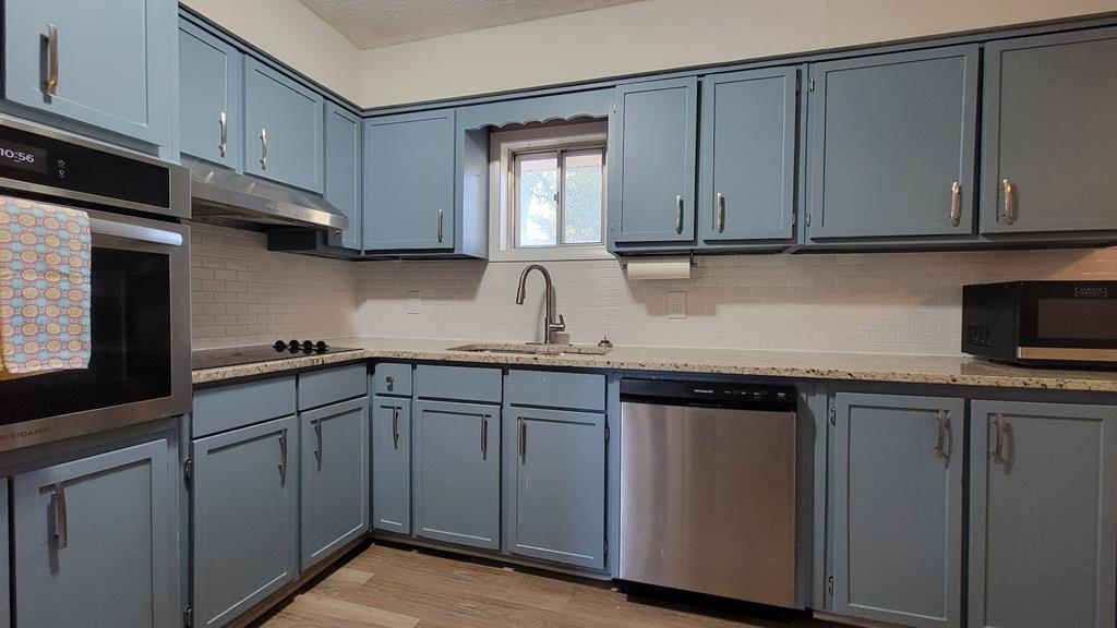 4804 Bruning Street Columbus, GA 31907 - Photo 3 of 14 a kitchen with stainless steel appliances granite countertop white cabinets sink and dishwasher