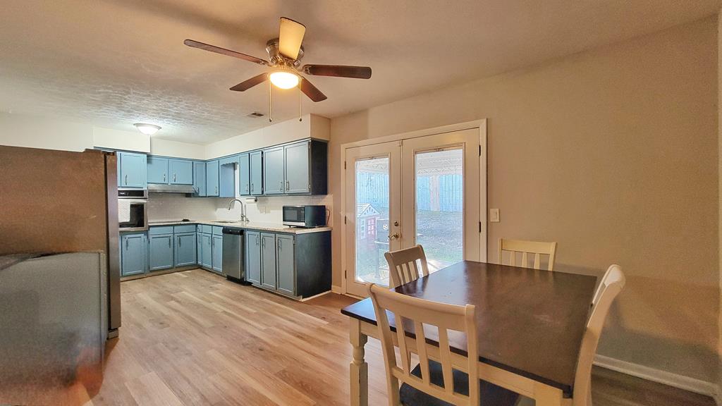 4804 Bruning Street Columbus, GA 31907 - Photo 5 of 14 a kitchen with stainless steel appliances granite countertop a microwave a stove and a refrigerator