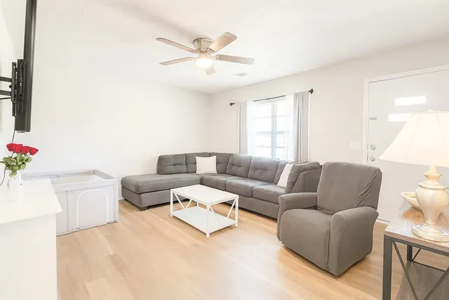 a living room with furniture and a chandelier