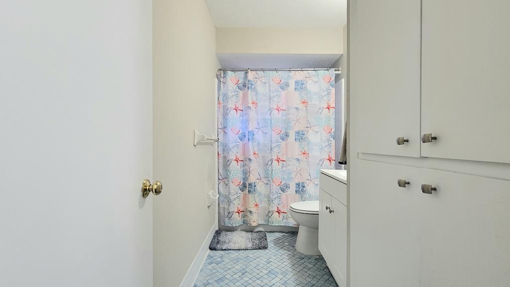 4804 Bruning Street Columbus, GA 31907 - Photo 10 of 14 a bathroom with a shower curtain and a toilet