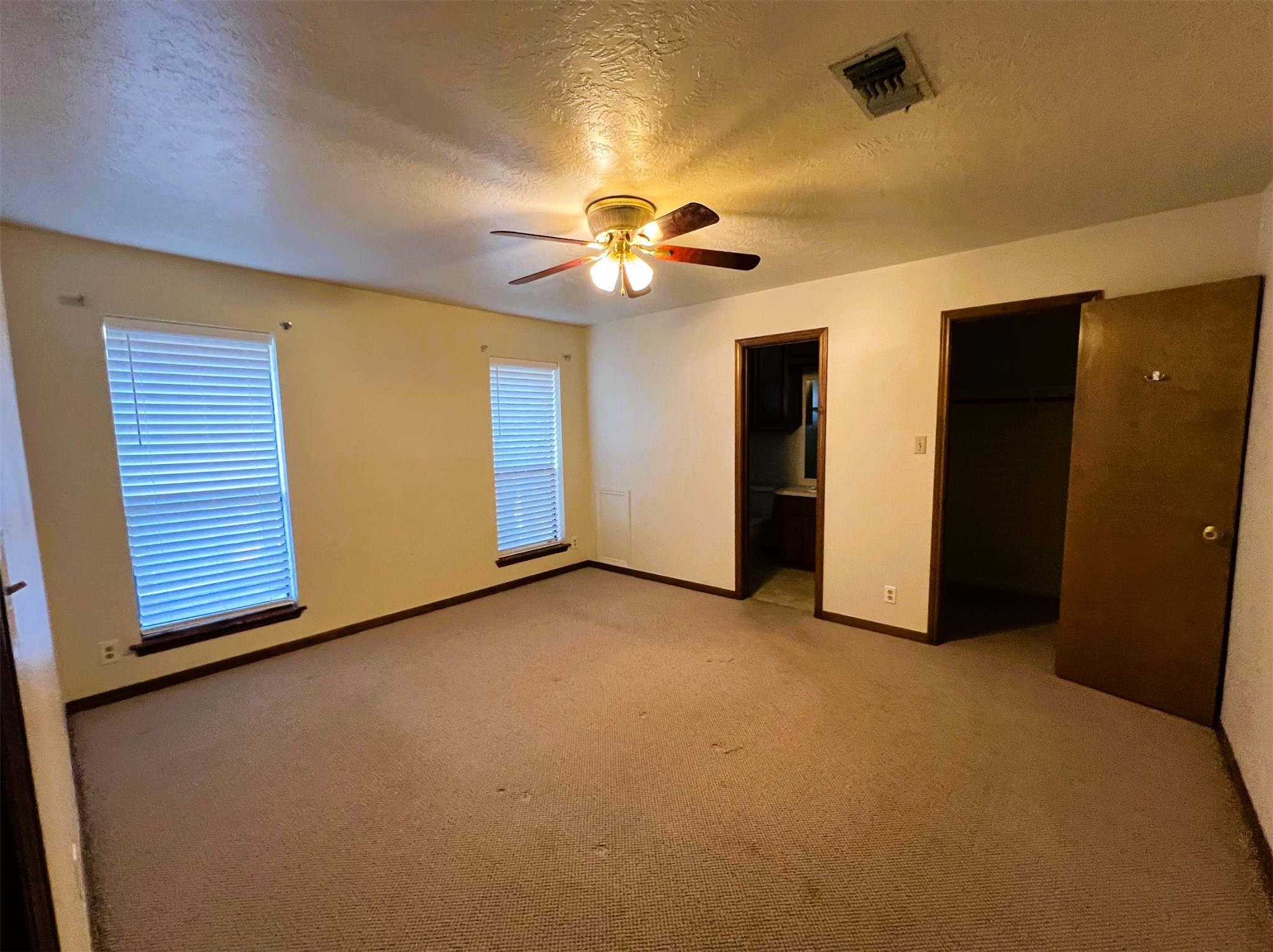 102 Briar Ridge Drive Bellville, TX 77418 - Photo 10 of 14 an empty room with closet and a chandelier fan