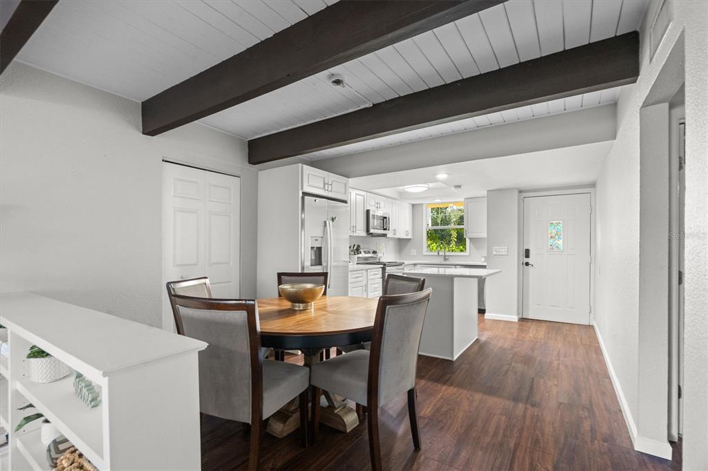 784 East Michigan Street, Unit 27 Orlando, FL 32806 - Photo 8 of 39 a view of a dining room with furniture and wooden floor