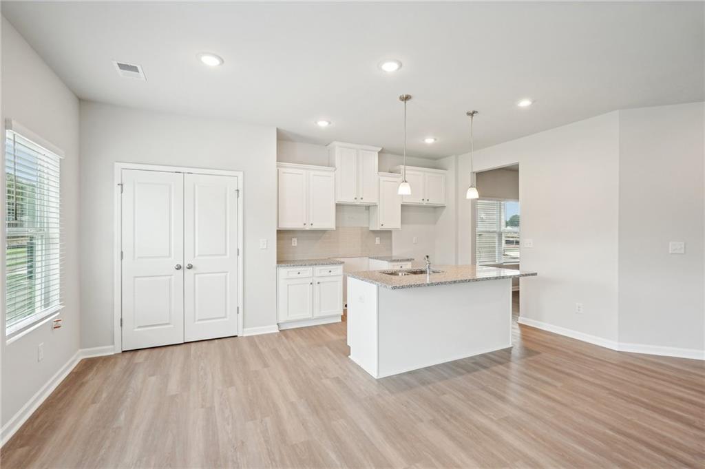 3014 Viewpark Circle Conyers, GA 30013 - Photo 13 of 44 a kitchen with a refrigerator and white cabinets