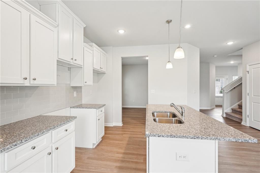 3014 Viewpark Circle Conyers, GA 30013 - Photo 15 of 44 a large kitchen with stainless steel appliances granite countertop a sink and white cabinets