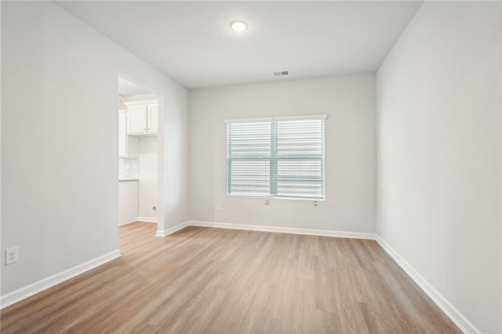 3014 Viewpark Circle Conyers, GA 30013 - Photo 19 of 44 an empty room with wooden floor and windows