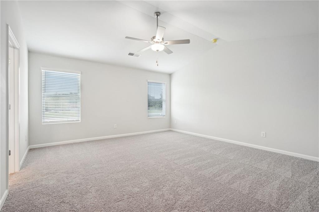 3014 Viewpark Circle Conyers, GA 30013 - Photo 21 of 44 an empty room with windows and fan