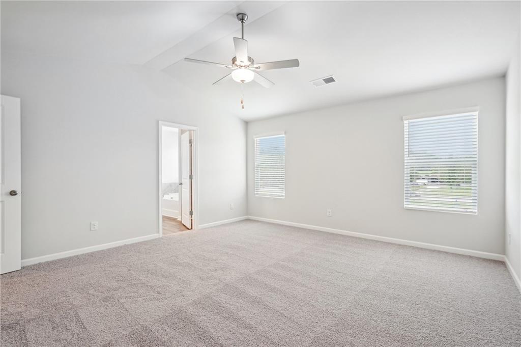 3014 Viewpark Circle Conyers, GA 30013 - Photo 22 of 44 an empty room with chandelier fan and windows