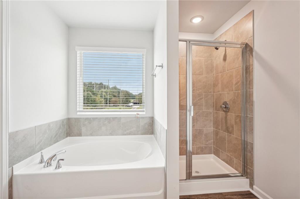 3014 Viewpark Circle Conyers, GA 30013 - Photo 27 of 44 a bathroom with a bathtub and a shower