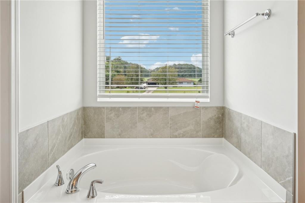 3014 Viewpark Circle Conyers, GA 30013 - Photo 28 of 44 a white bath tub sitting in a bathroom next to a window