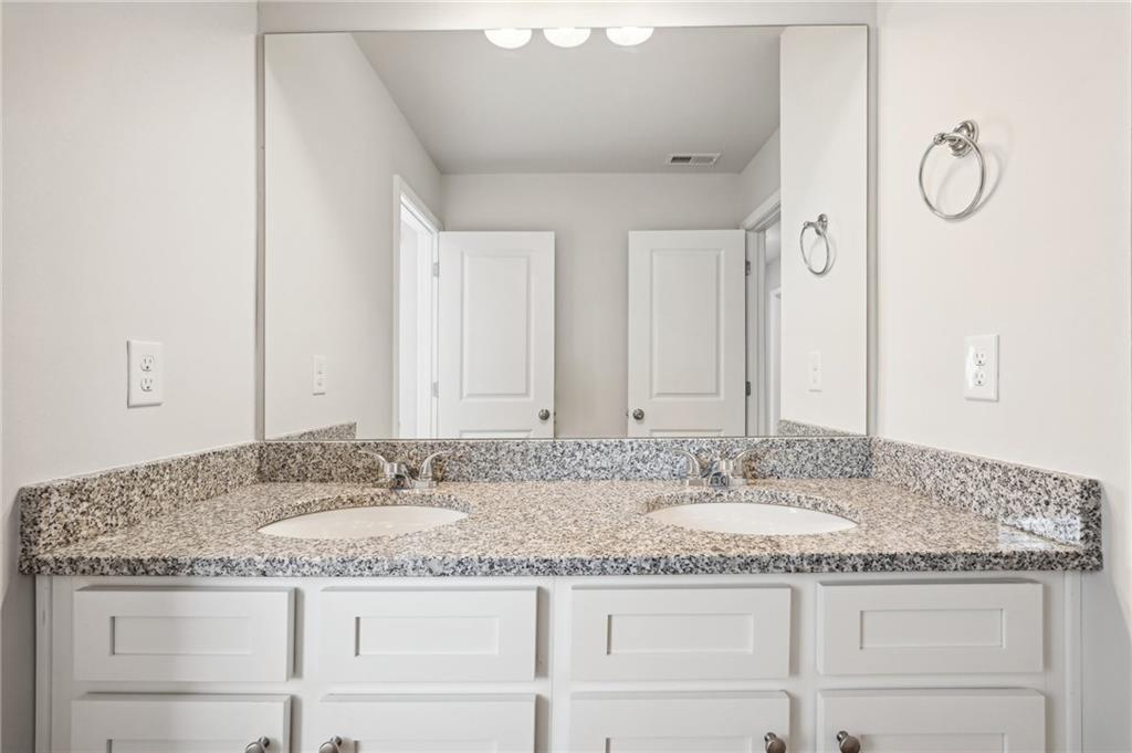 3014 Viewpark Circle Conyers, GA 30013 - Photo 35 of 44 a bathroom with a granite countertop sink and a mirror
