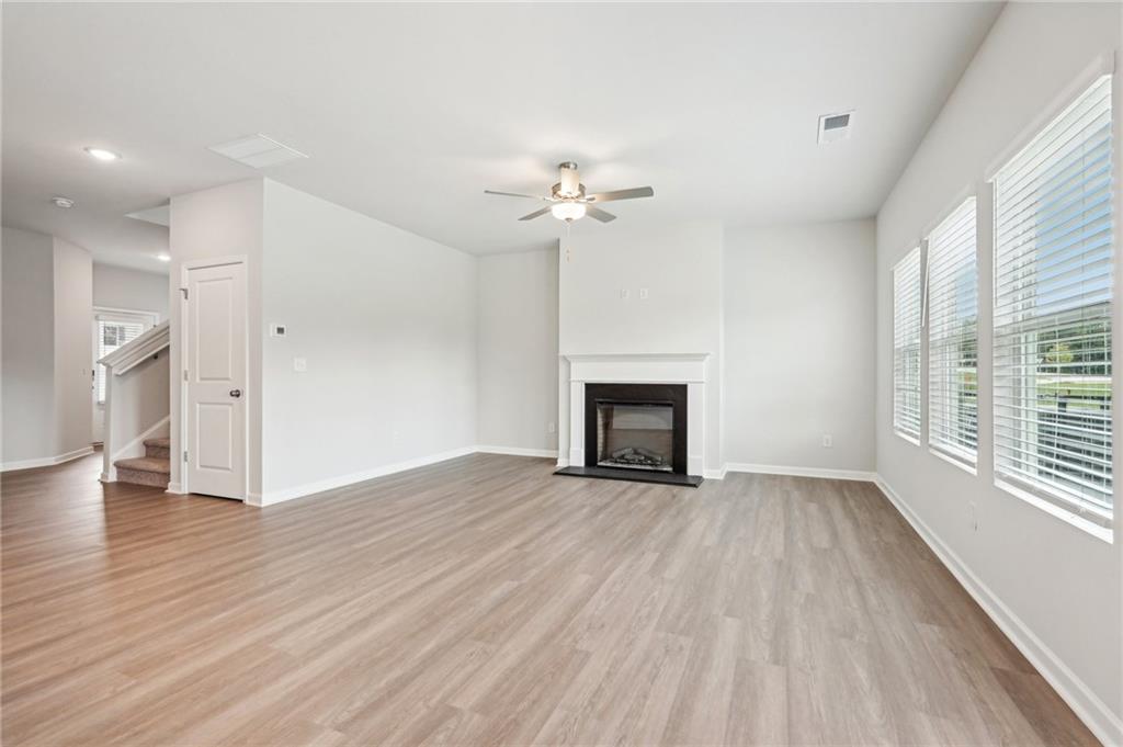 3014 Viewpark Circle Conyers, GA 30013 - Photo 7 of 44 a view of empty room with wooden floor and fan