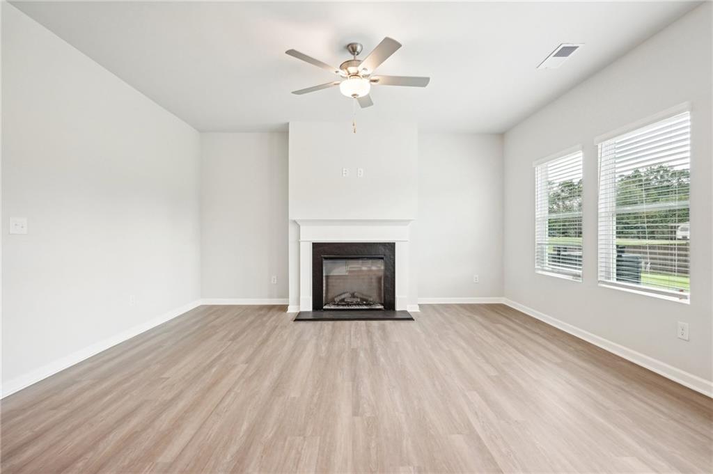 3014 Viewpark Circle Conyers, GA 30013 - Photo 8 of 44 wooden floor fireplace and windows in a room