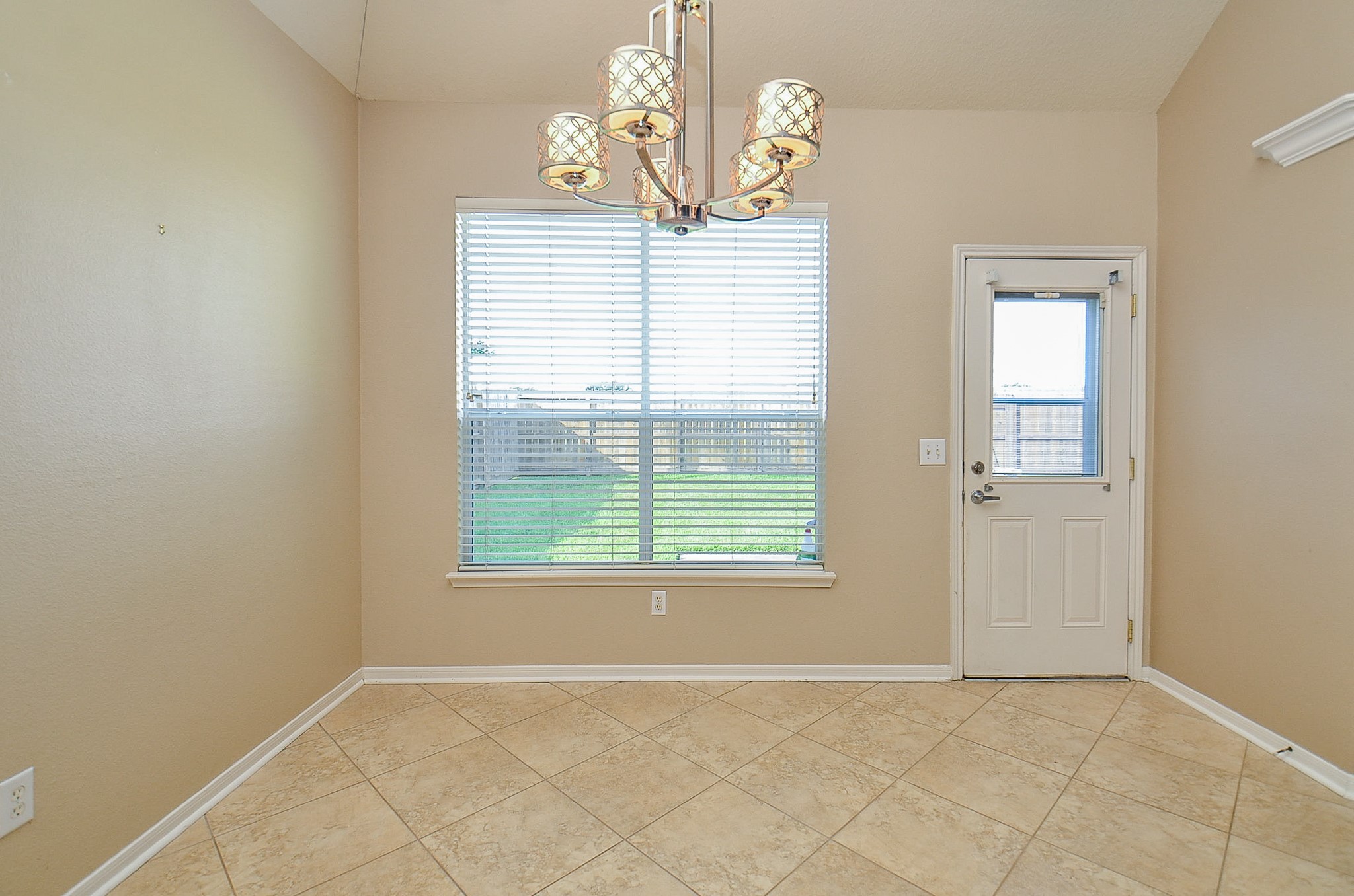 1222 Ragsdale Lane Katy, TX 77494 - Photo 11 of 31 an empty room with windows and chandelier