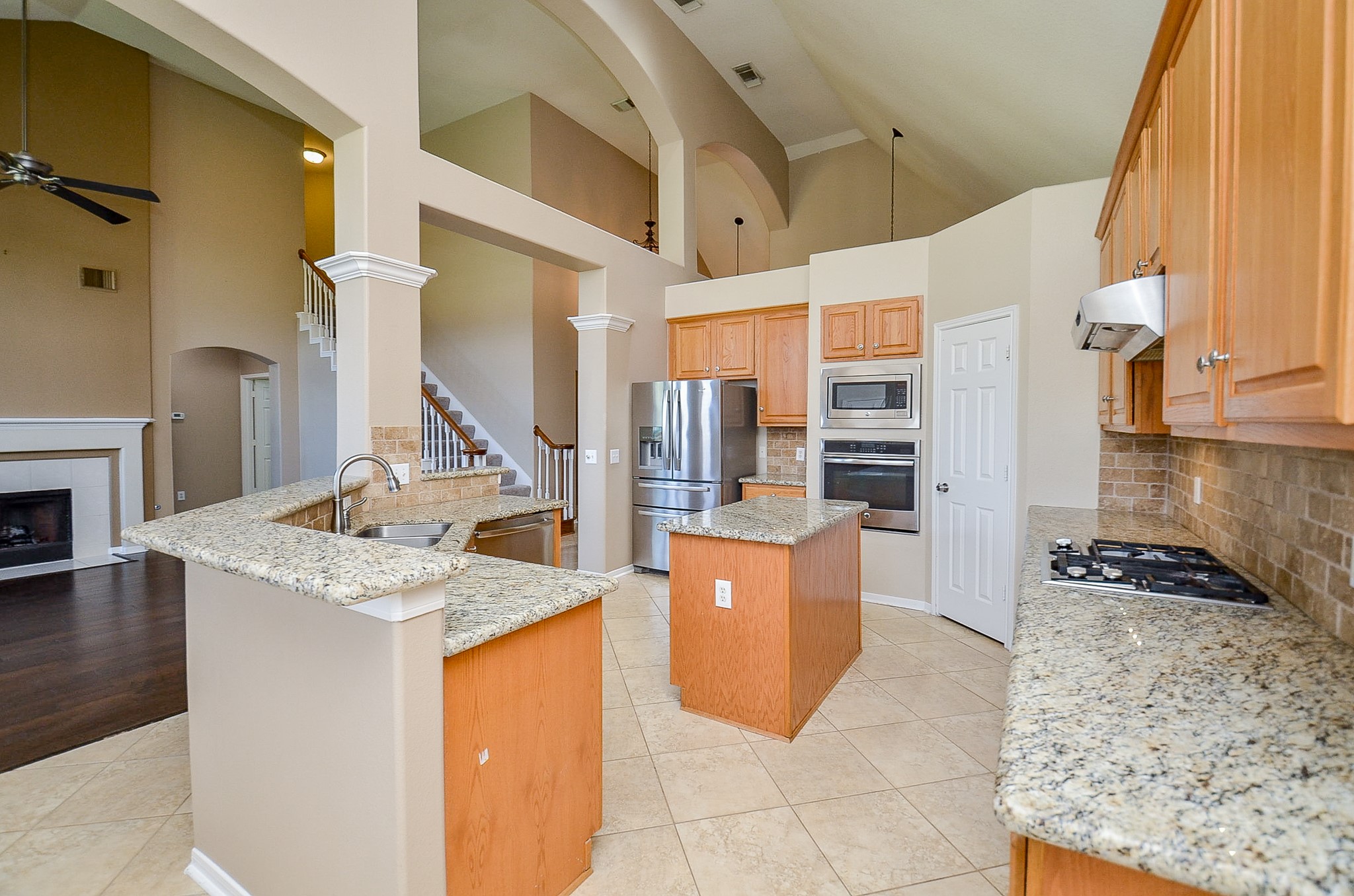 1222 Ragsdale Lane Katy, TX 77494 - Photo 13 of 31 a kitchen with granite countertop a stove and a refrigerator
