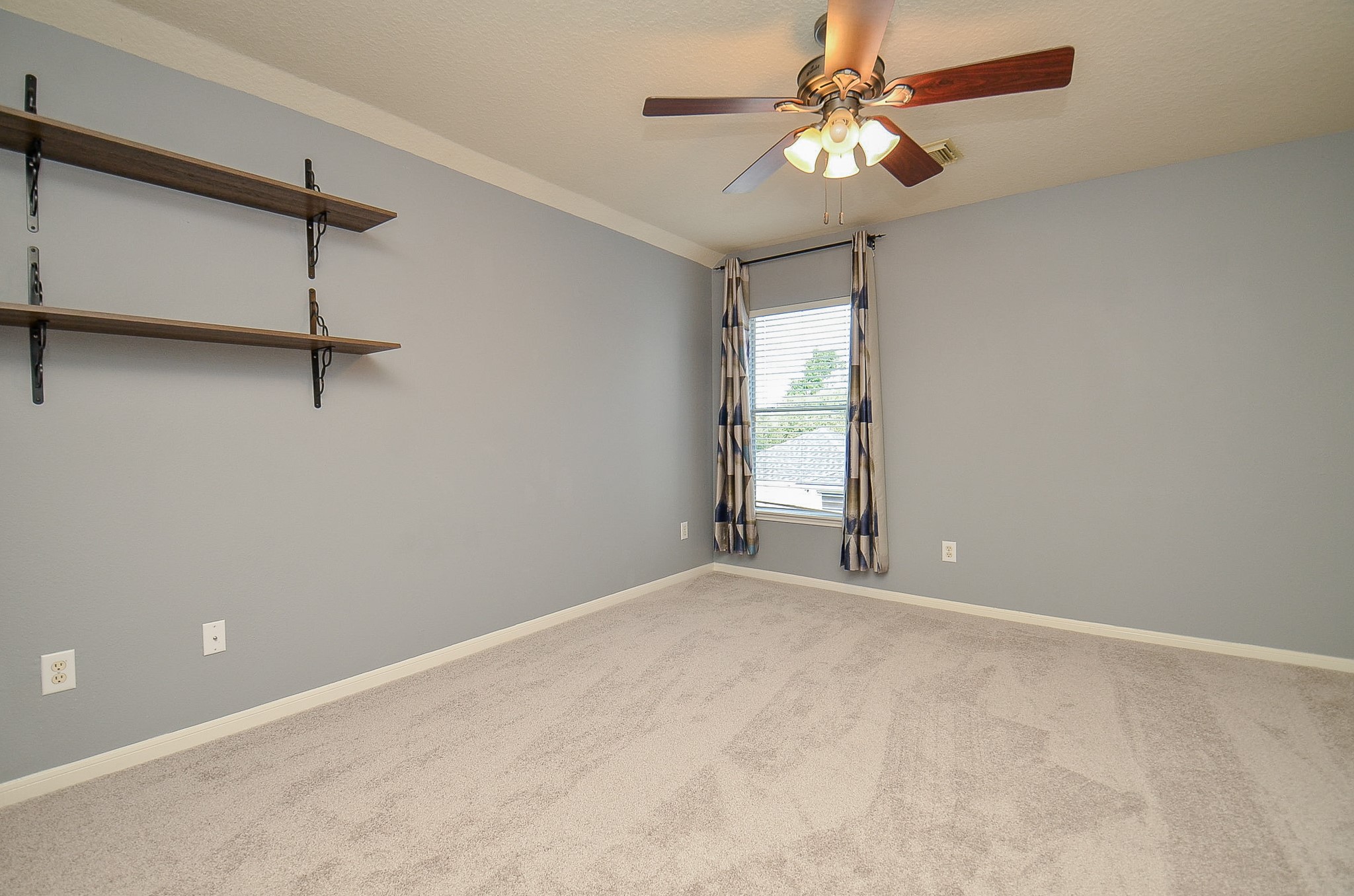 1222 Ragsdale Lane Katy, TX 77494 - Photo 21 of 31 a view of a room with a ceiling fan and a window