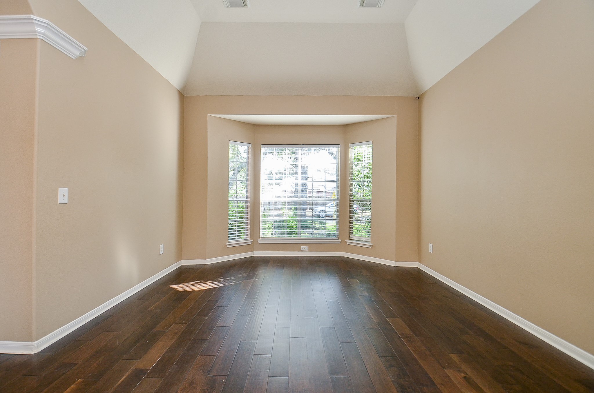 1222 Ragsdale Lane Katy, TX 77494 - Photo 5 of 31 a view of an empty room with wooden floor and a window