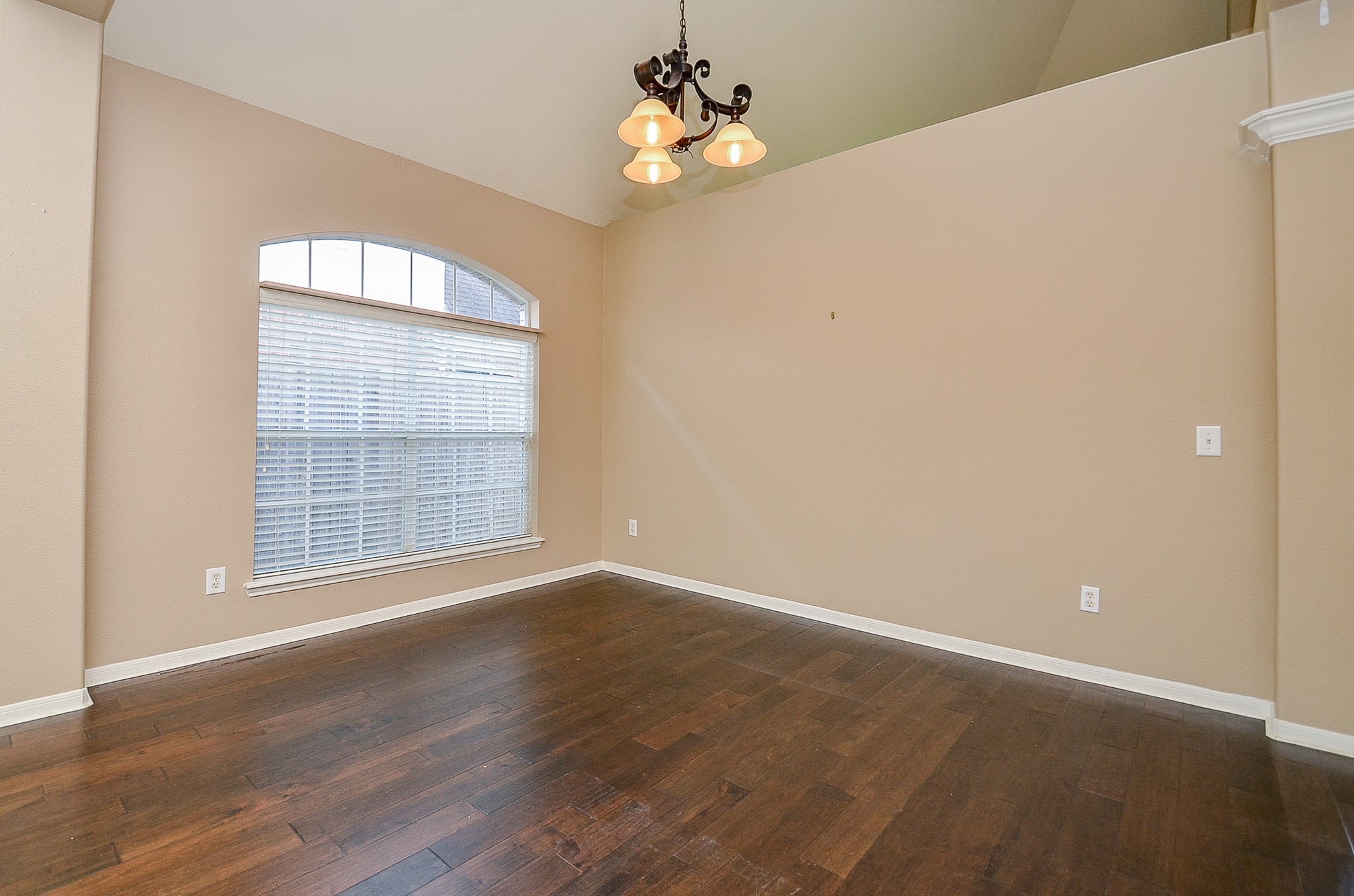 1222 Ragsdale Lane Katy, TX 77494 - Photo 6 of 31 a view of an empty room with wooden floor and a window