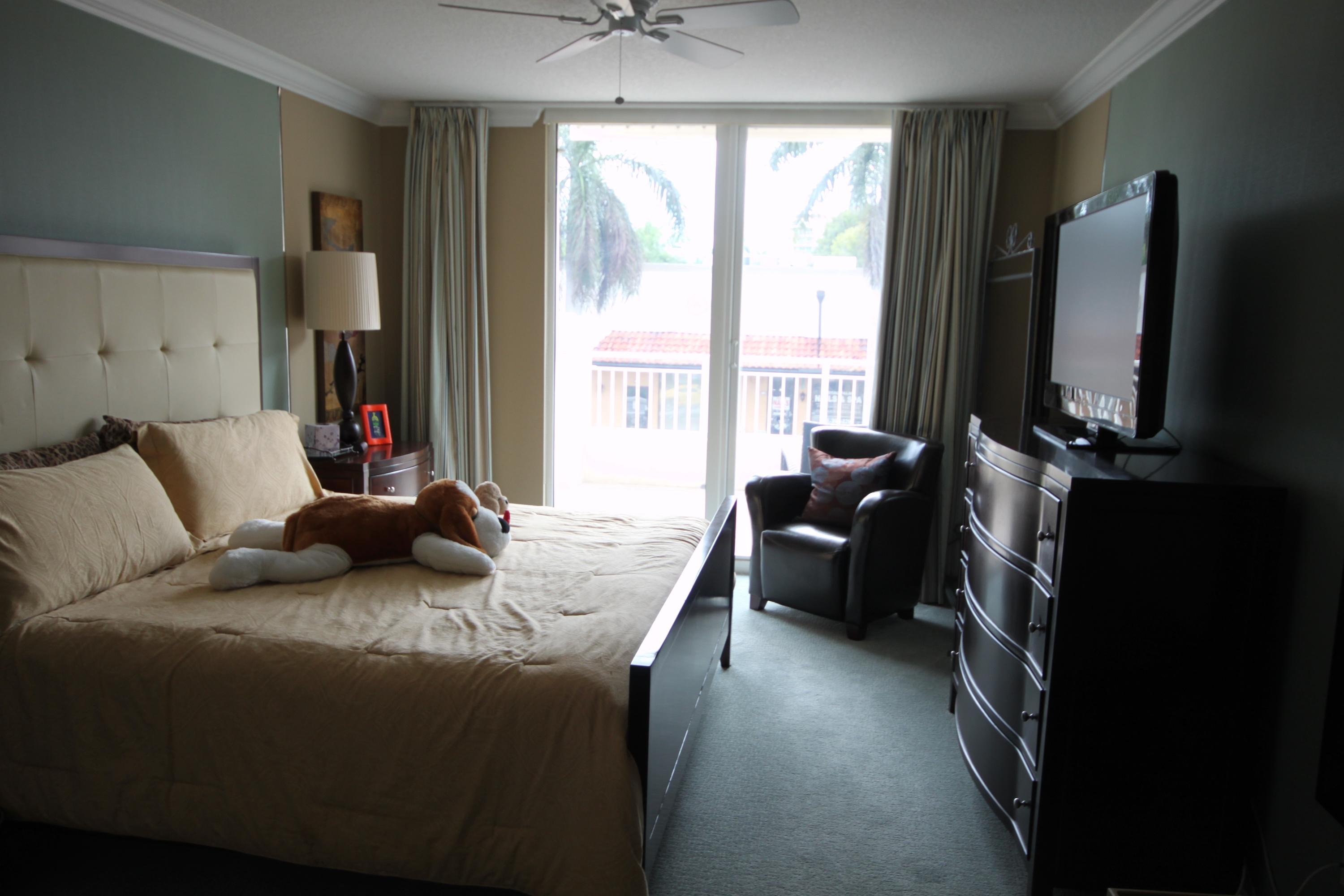 99 Southeast Mizner Boulevard, Unit 219 Boca Raton, FL 33432 - Photo 11 of 14 a living room with furniture and a flat screen tv