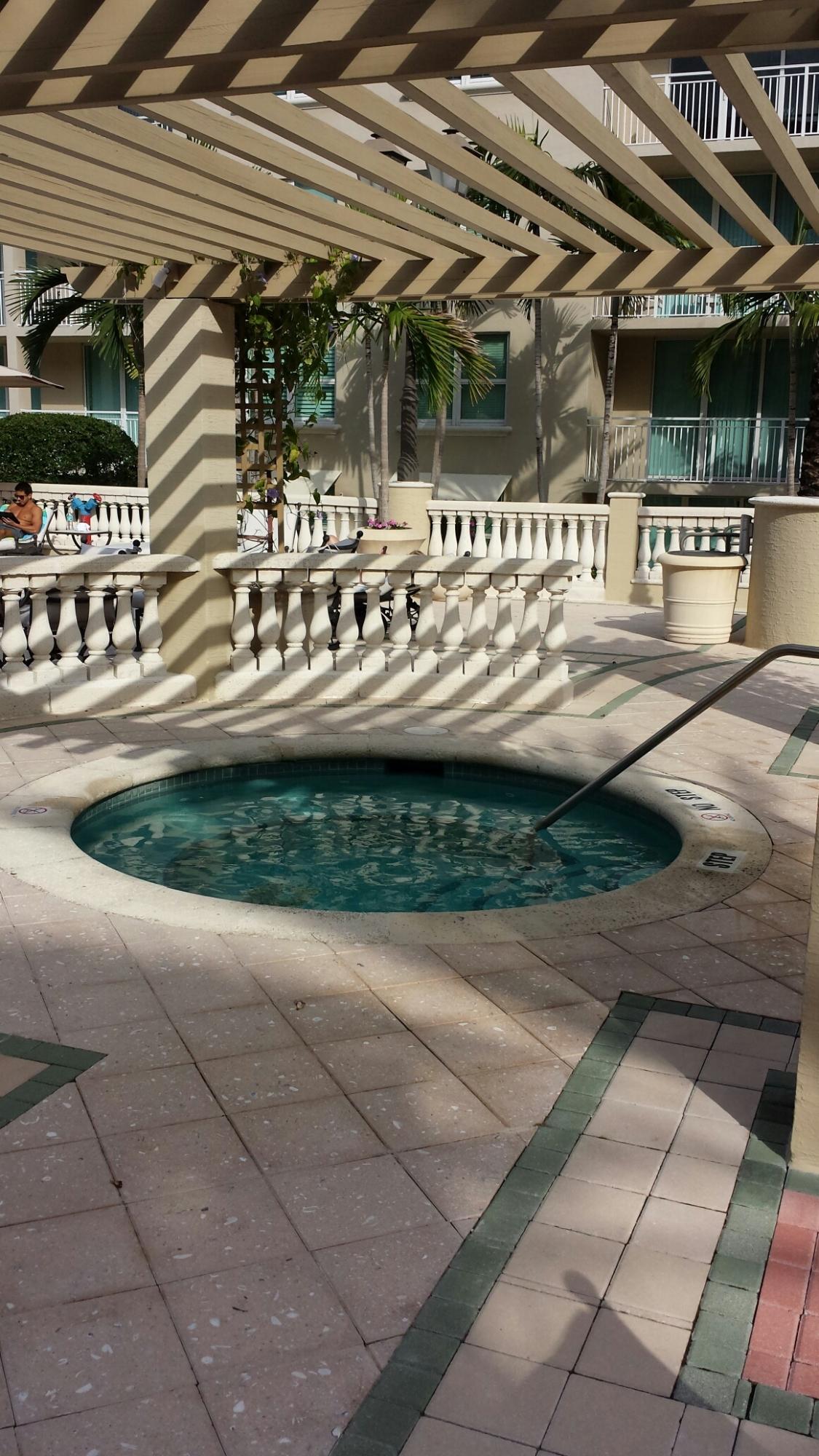 99 Southeast Mizner Boulevard, Unit 219 Boca Raton, FL 33432 - Photo 3 of 14 a view of a patio with table and chairs with wooden floor