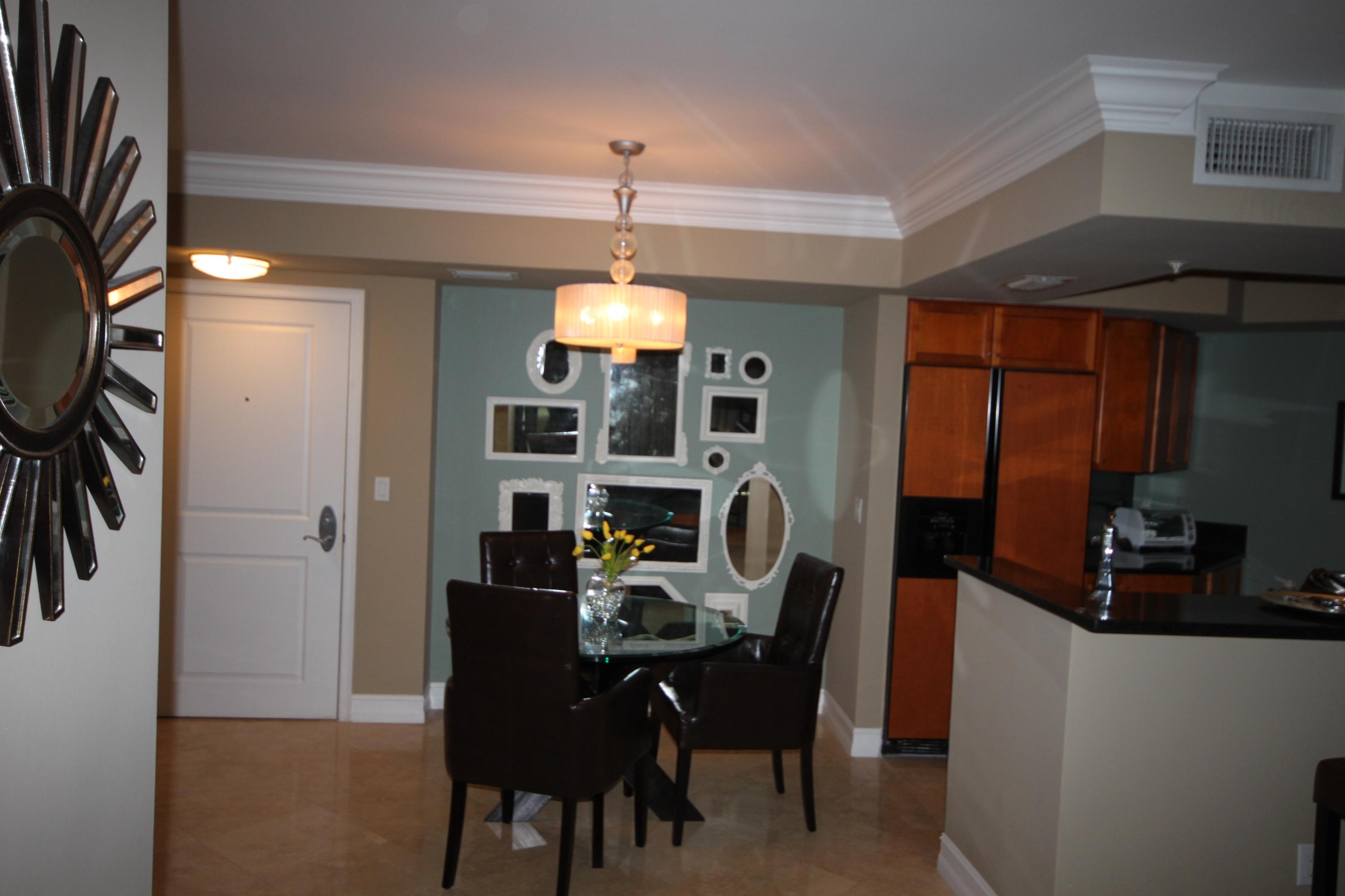 99 Southeast Mizner Boulevard, Unit 219 Boca Raton, FL 33432 - Photo 8 of 14 a view of a dining room with furniture and chandelier