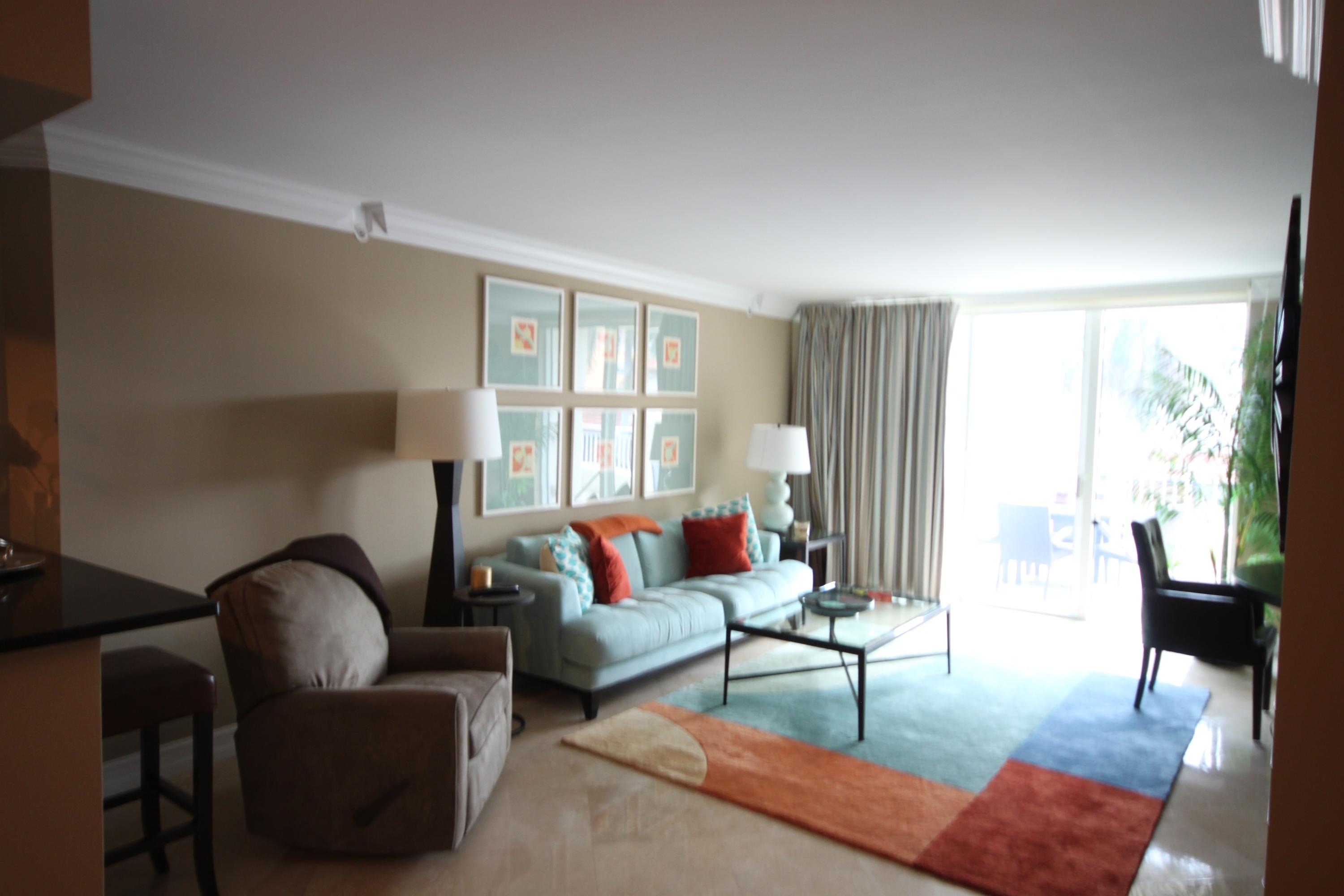 99 Southeast Mizner Boulevard, Unit 219 Boca Raton, FL 33432 - Photo 10 of 14 a living room with furniture and a large window