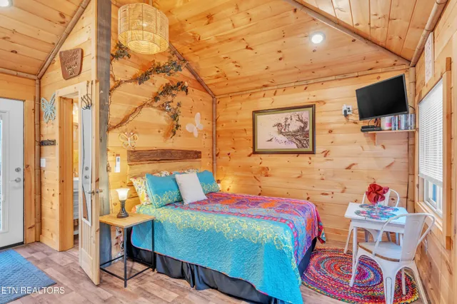 a bedroom with furniture and a large window