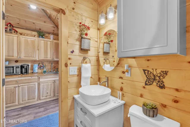 a view of a patio with table and chairs with wooden floor and fence