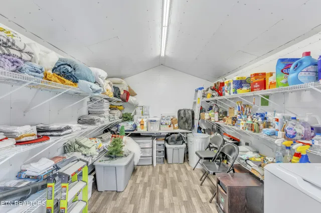 a view of a brick house with a bench and table chair