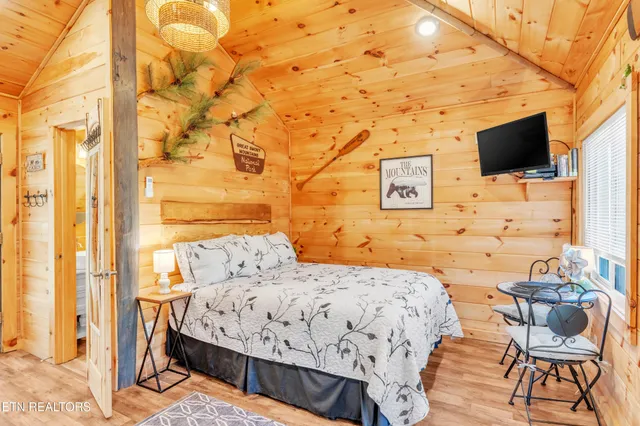 a bedroom with a bed and flat screen tv