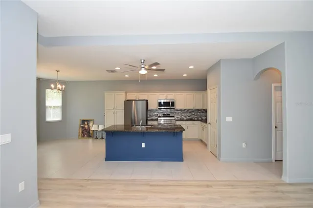 a living room with kitchen island granite countertop furniture and a view of kitchen