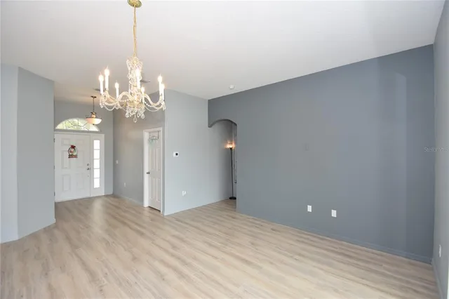 a view of a chandelier in big room and chandelier