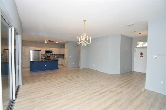 a view of a kitchen with a sink and a large mirror