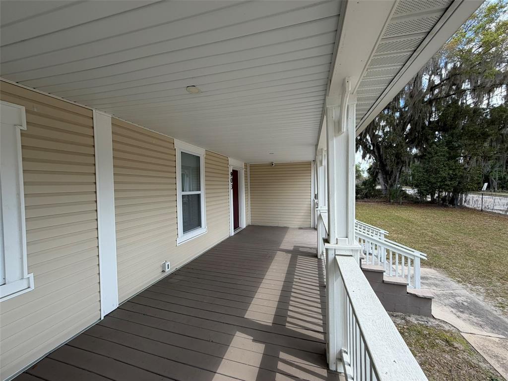 903 East New York Avenue DeLand, FL 32724 - Photo 6 of 29 a view of a balcony with wooden floor