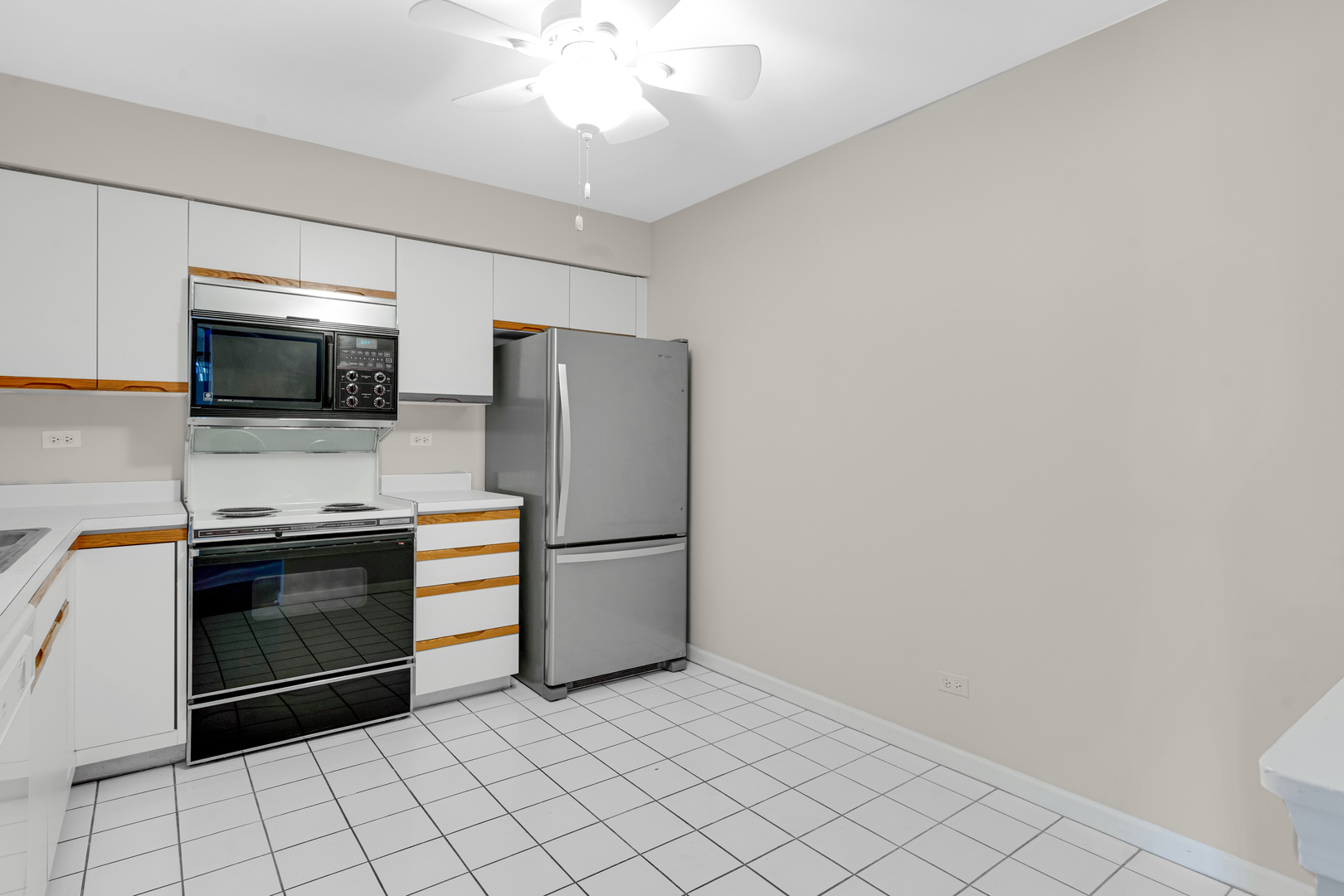 400 East Dundee Road, Unit 408 Buffalo Grove, IL 60089 - Photo 11 of 24 a kitchen with stainless steel appliances a refrigerator and a stove top oven