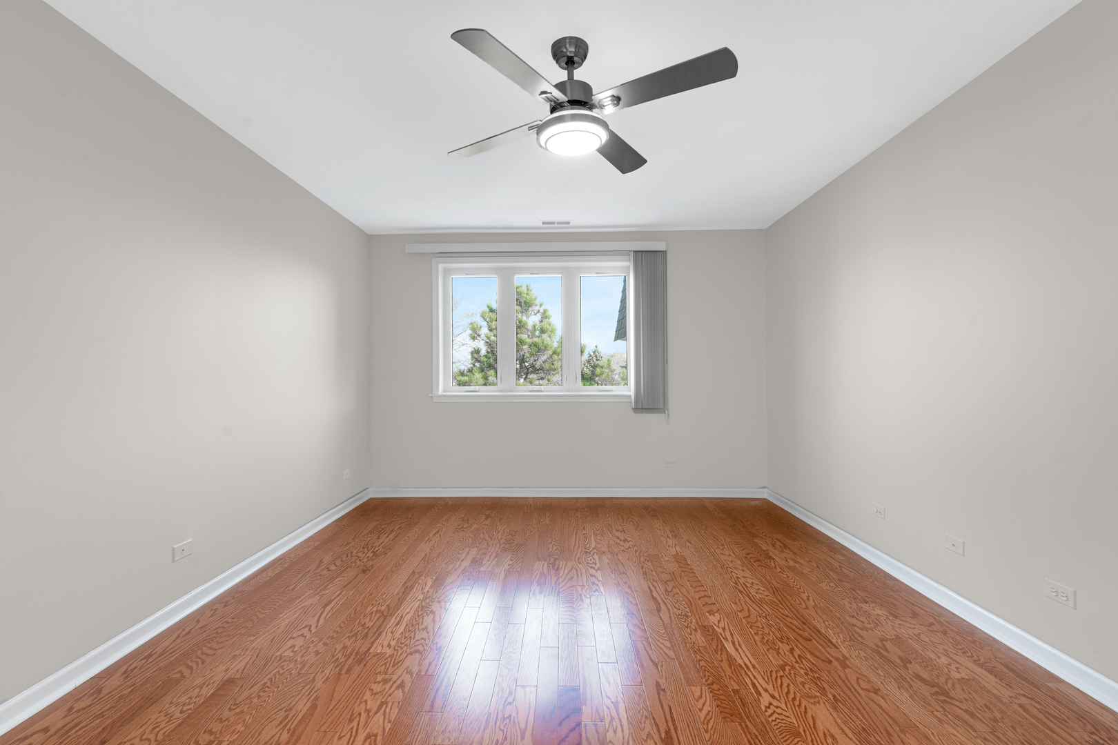 400 East Dundee Road, Unit 408 Buffalo Grove, IL 60089 - Photo 13 of 24 an empty room with wooden floor and windows