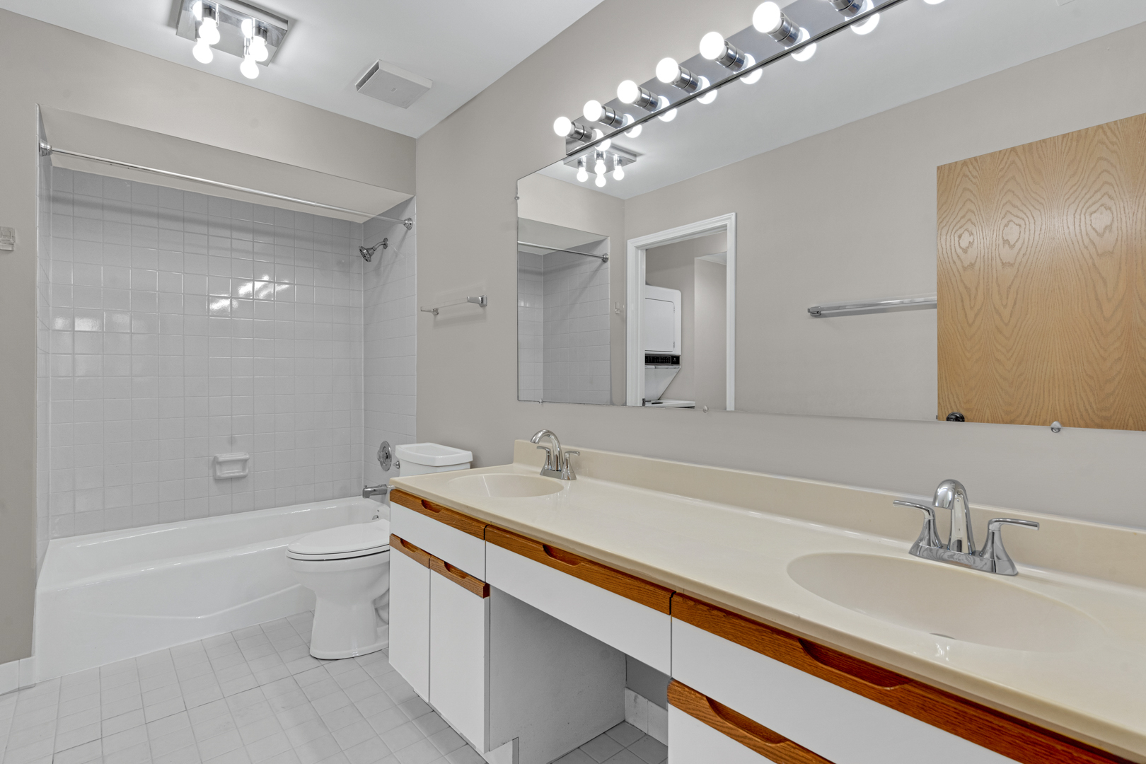 400 East Dundee Road, Unit 408 Buffalo Grove, IL 60089 - Photo 16 of 24 a bathroom with a sink a toilet and a large mirror