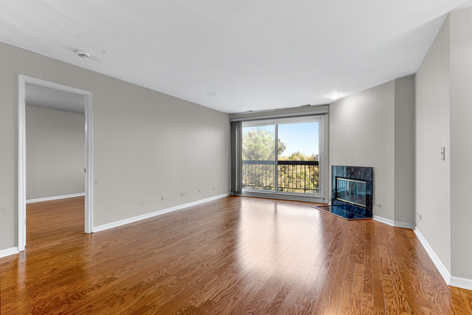 400 East Dundee Road, Unit 408 Buffalo Grove, IL 60089 - Photo 4 of 24 a view of an empty room with wooden floor and a window