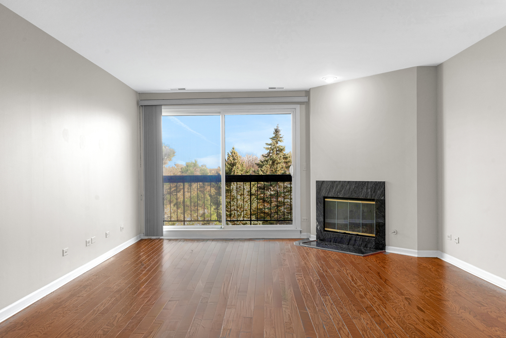 400 East Dundee Road, Unit 408 Buffalo Grove, IL 60089 - Photo 5 of 24 an empty room with wooden floor fire place and windows