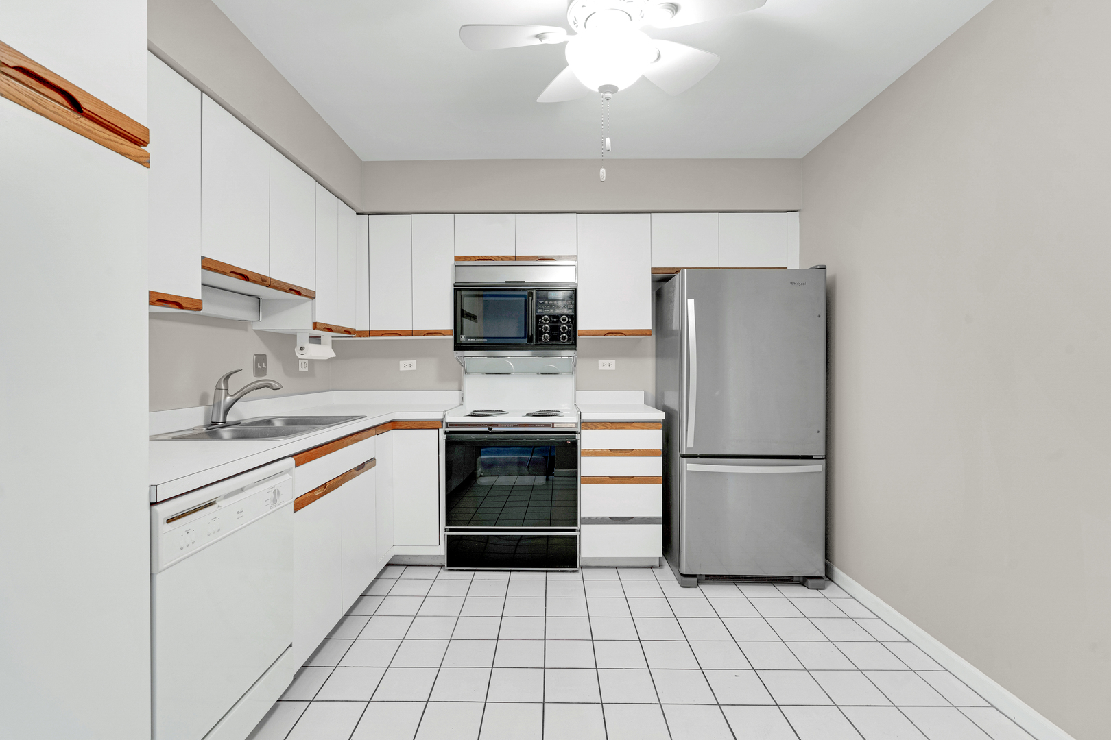 400 East Dundee Road, Unit 408 Buffalo Grove, IL 60089 - Photo 10 of 24 a kitchen with a refrigerator sink and cabinets