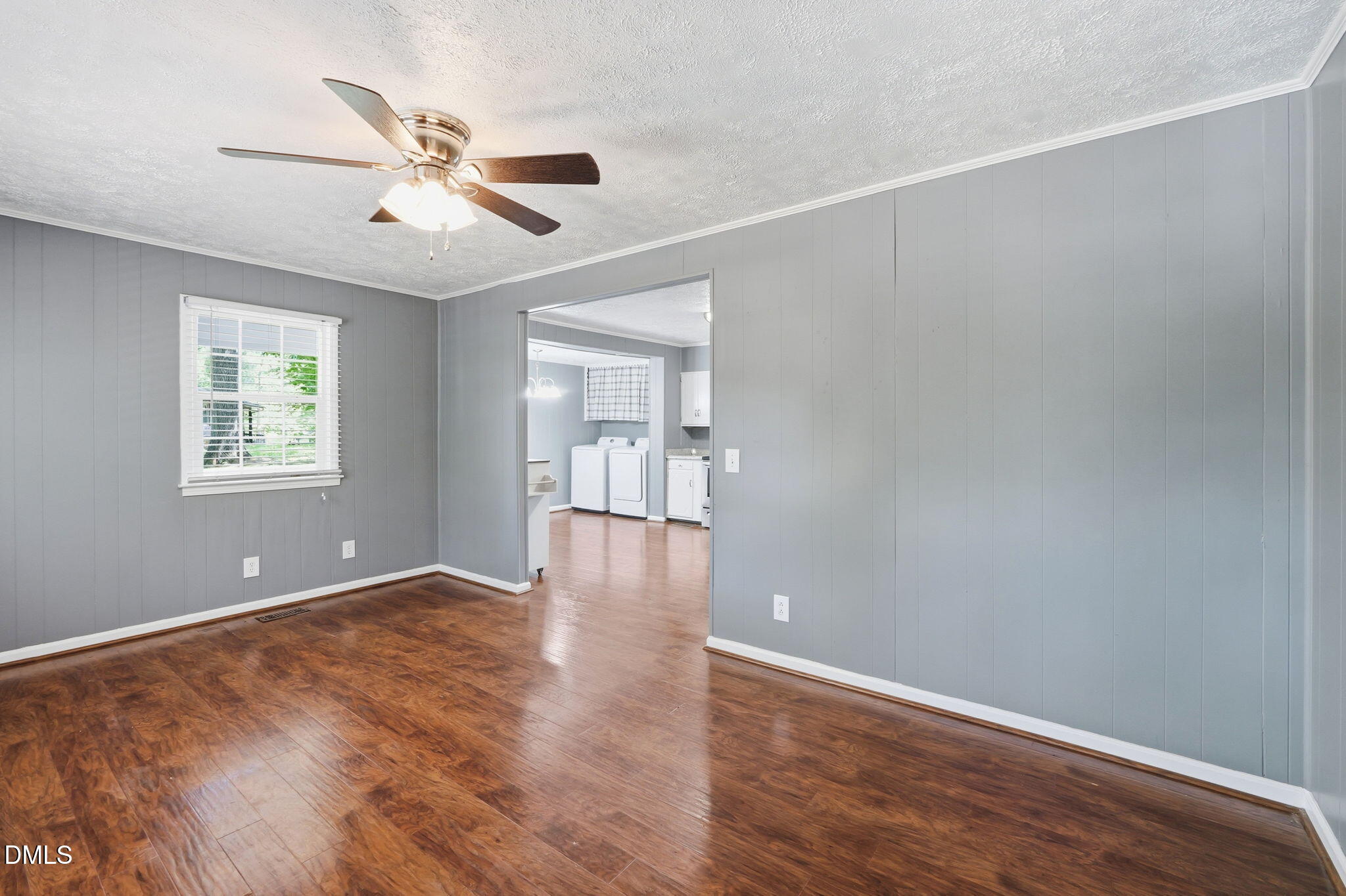 265 Shady Hill Circle Roxboro, NC 27573 - Photo 4 of 18 a view of an empty room with a window and wooden floor