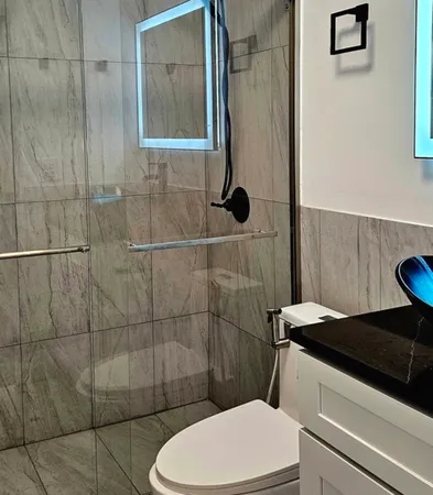 a bathroom with a toilet and a shower